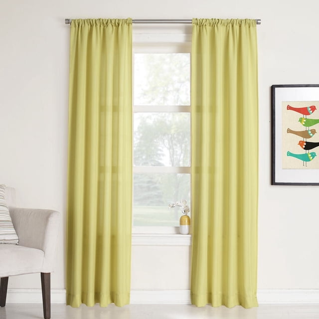 918 Rapture Rod Pocket Sheer Curtain in light yellow hanging on a silver rod over a white-framed window, filtering light and enhancing privacy with relaxed cotton-look polyester fabric, in a bright room with white walls, beige armchair, and framed bird artwork.
