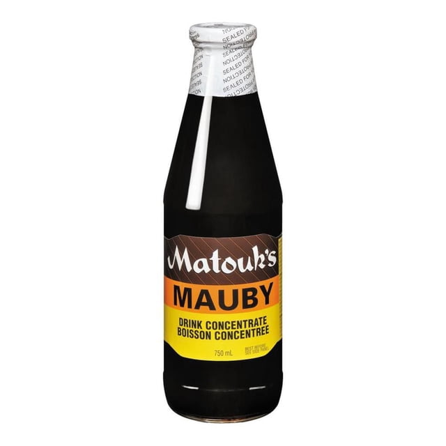Matouks Mauby Concentrate in a 750 ml dark glass bottle with a white sealed cap, featuring a brown, orange, and yellow label describing it as a Caribbean bark-based drink concentrate that is bitter but can be sweetened with water, often used to prepare traditional Caribbean beverages.