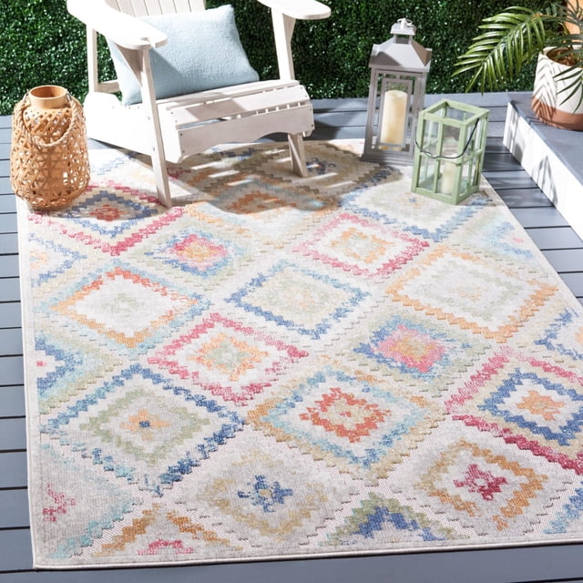 SAFAVIEH Cabana Carina Tapis Géométrique Intérieur/extérieur avec Motifs de Losanges pastel en Bleu, Rose, orange et Vert sur Fond beige, Posé sur une Terrasse Extérieure Grise avec une Chaise Adirondack Blanche, un Coussin Bleu, une Lanterne Tissée et Deux Lanternes à Bougie, Conçu pour la Durabilité contre les Intempéries et la Décoloration, Convient Aussi aux Zones Intérieures Occupées.