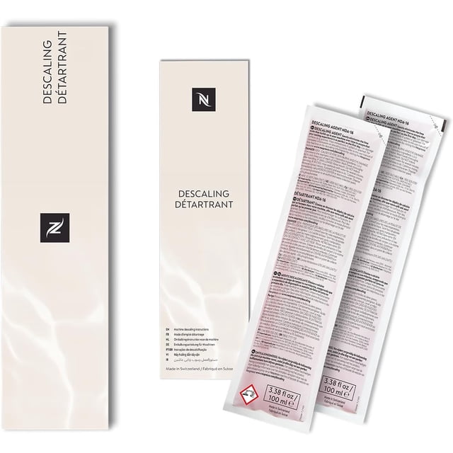 Nespresso Descaling Solution, Fits all Models, 2 Packets. Includes two 100ml packets of descaling agent compatible with all Nespresso machines, including OriginalLine and VertuoLine models like Lattissima, Le Cube, Inissia, and Citiz. The solution effectively removes lime scale buildup to maintain optimal coffee taste. The packaging features a sleek design with multilingual instructions.