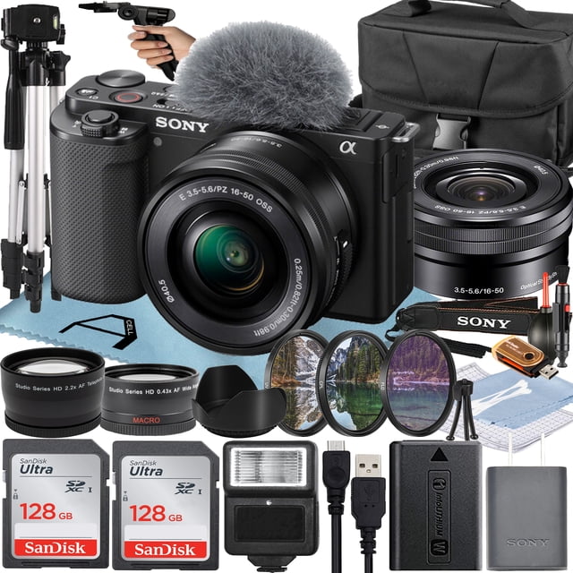 Sony Alpha ZV-E10 mirrorless vlog camera in black with a 16-50mm lens, shown alongside a comprehensive A-Cell Mobility accessory bundle. The bundle includes two 128GB SanDisk Ultra SDHC memory cards, a flash, a 50-inch tripod, a pistol grip tripod, a camera case, auxiliary telephoto and wide-angle lenses, a lens hood, a 3-piece filter kit, a memory card reader, a cleaning kit, a blower, a microfiber cleaning cloth, and more. The camera features a 3.0-inch flip-out touchscreen LCD, a directional 3-capsule microphone with a windscreen, and Face-Priority AE for optimized exposure. Ideal for vloggers and content creators.