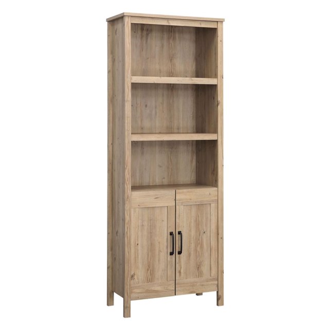Sauder Miscellaneous Storage Bookcase in Khaki Pine finish, designed for kids' rooms with five shelves, including three adjustable ones and two concealed behind double doors for hidden storage. Perfect for organizing books, toys, or kids' décor.