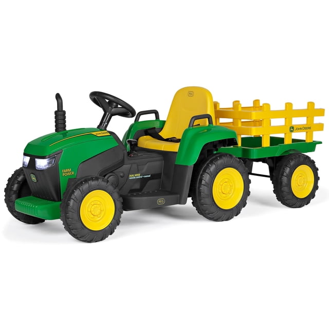 Peg Perego John Deere Farm Power 12 Volt Ride-on Tractor and Trailer with Remote Control, green and yellow ride-on toy tractor featuring large treaded black wheels, yellow seat with safety belt, detachable yellow stake-side trailer, working headlights, realistic John Deere logos, and dual mode remote control for parent safety.