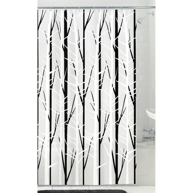 Mainstays Woodland PEVA shower curtain with black and white tree branch design on a frosty translucent background, measuring 70 by 72 inches, hanging in a white tiled bathroom with chrome showerhead and tub, ideal for standard shower or tub spaces.