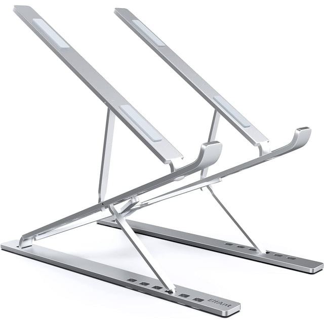 Laptop Stand, Adjustable ABS plastic Notebook Stand in grey, featuring a foldable and portable design. The stand offers 9+6 height choices, adjustable from 2.75” to 12.6” (7cm to 32cm), and includes ergonomic features to prevent cervical spine strain. It has two rubber mats on the hook and four anti-skid silicone pads for stability. Compatible with laptops and tablets ranging from 10 to 15.6 inches, including MacBook Air/Pro, Google Pixelbook, Dell XPS, HP, ASUS, Lenovo ThinkPad, Acer, Chromebook, Samsung, and iPad. Suitable for use at home, office, cafes, and outdoor settings.