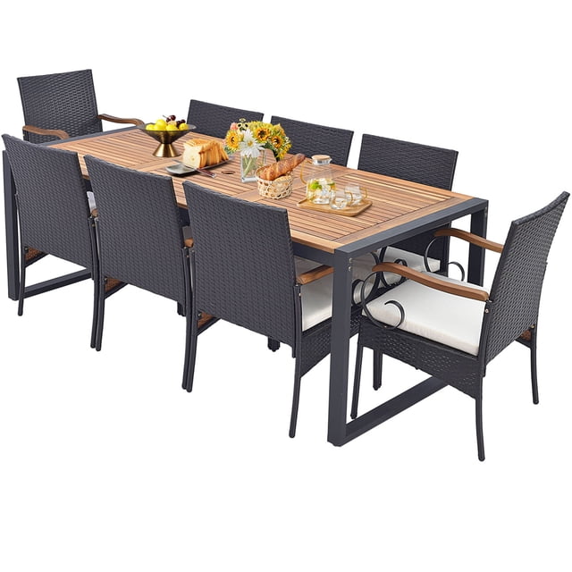 Gymax 9 PCS Outdoor Metal Dining Table & Rattan Chairs w/ Acacia Wood Table. This 9-piece patio dining set includes a rectangular acacia wood table with a 1.9'' umbrella hole and eight ergonomic rattan chairs with off-white cushions. The mix brown PE rattan and heavy-duty metal frame ensure durability and fade resistance. Chairs can be tucked under the table to save space. Ideal for outdoor gatherings, the set combines rustic aesthetics with functionality.