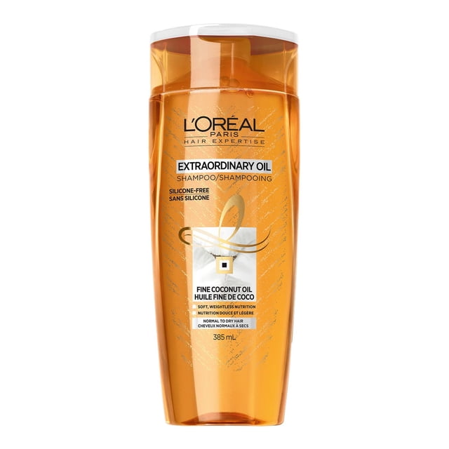 L'Oréal Paris Hair Expertise Extraordinary Oil Shampoo in a translucent amber plastic bottle with white flip cap, enriched with fine coconut oil for soft, weightless nutrition, silicone-free formula, designed for normal to dry hair, 385 ml.