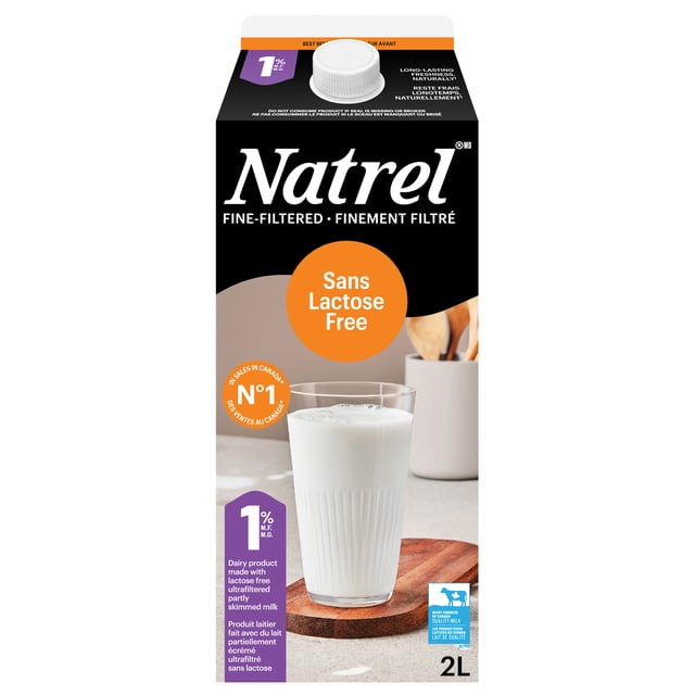 Natrel Lactose Free 1% milk carton with white screw cap, featuring a glass of milk on a wooden coaster, labeled fine-filtered and lactose free, an excellent source of calcium, vitamin D, and protein, partly skimmed 2L Canadian dairy product ideal for cooking and frothing.