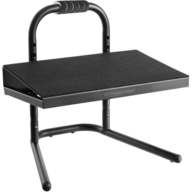 Ergonomic All-Steel Standing Footrest by PrimeCables, featuring a black powder-coated finish and a padded non-slip platform. This footrest offers 6 height adjustment settings ranging from 153 mm to 278 mm, supporting up to 55 lbs. Designed with a 10° angled platform and a soft grip handle for portability, it is ideal for improving posture at standing desks or extended-height chairs. Dimensions: 15.7 x 13.3 x 14.4 inches.