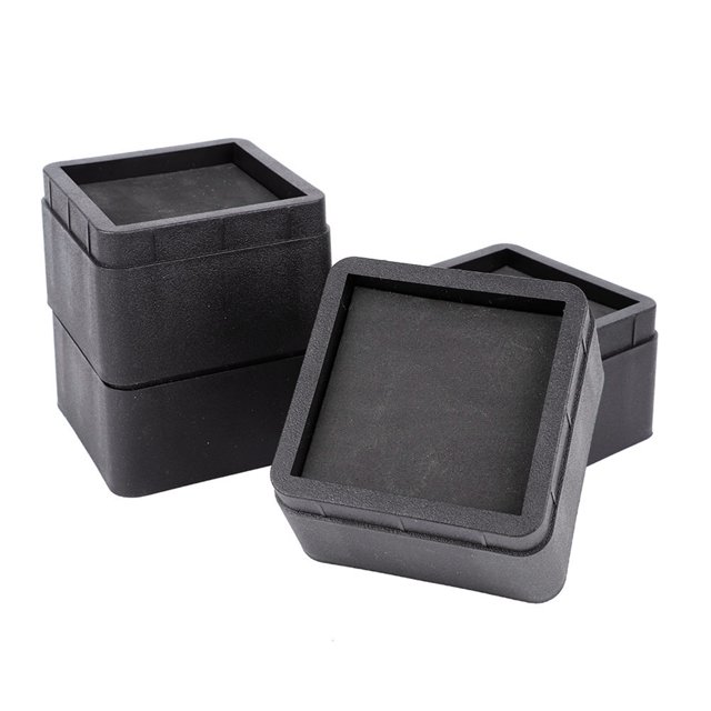 Herwey 4PCS Durable Stackable Bed Risers in black, made of premium ABS material. These square furniture risers measure approximately 10.6 x 10.6 x 6.5 cm (4.2 x 4.2 x 2.6 inches) and are designed to elevate beds, sofas, desks, and chairs. The smooth edges protect floors and carpets from scratches. Ideal for creating additional storage space under furniture with a stackable design for adjustable height.