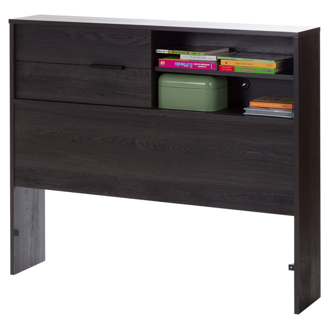 South Shore Fynn Twin Bookcase Headboard with Storage in gray oak finish, front view showing a modern headboard with four compartments including two open shelves holding books and a green storage box, and two compartments hidden behind a sliding door, featuring a cable management hole for bedroom organization.