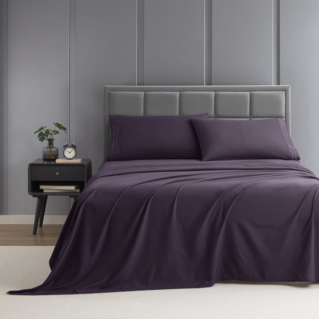 Nestl Split King Sheet Set, 1800 Series Microfiber Deep Pocket 4 Piece Bed Sheet Set displayed on a bed in a modern bedroom setting. The set includes two 39 x 80 inch fitted sheets, one 102 x 108 inch flat sheet, and two 20 x 40 inch pillowcases. The sheets are made of double-brushed microfiber fabric, offering a soft, silky texture and hotel-quality comfort. The deep pocket design fits mattresses up to 16 inches, ensuring a snug and wrinkle-free fit. The bedding is shown in a rich, dark purple color with a subtle stripe detail, complementing the contemporary decor of the room. Ideal for a serene sleeping experience, the sheets are breathable, hypoallergenic, and resistant to pilling and snagging. Suitable for use with memory foam mattress toppers or pads.