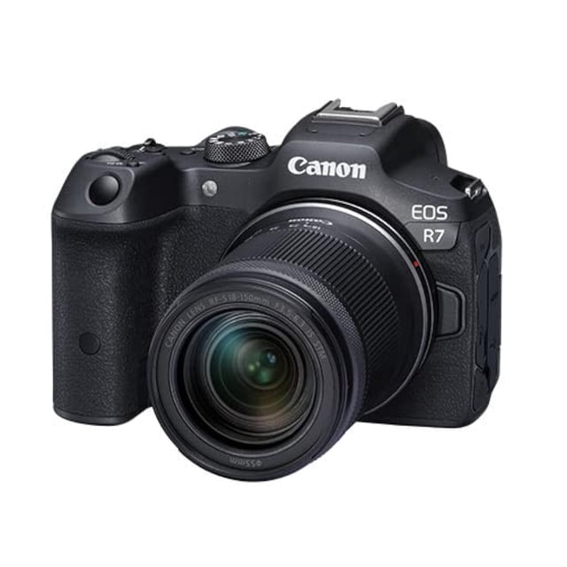 Canon EOS R7 Mirrorless Camera with RF-S 18-150mm Lens Kit displayed in a front-facing view. This advanced APS-C camera features a 32.5 MP CMOS sensor, 15 FPS mechanical shutter, and 5-axis in-body stabilization up to 7 stops. The RF-S 18-150mm F3.5-6.3 IS STM lens provides a versatile zoom range for standard-angle to telephoto shots. Designed for high-speed autofocus, capturing fast action, wildlife, and professional-quality 4K60p video.