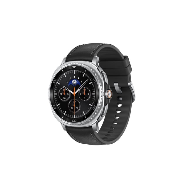Samsung Galaxy Watch8 Classic 46mm BT with a round silver stainless steel case and black leather strap, showing a black dial with three subdials, orange and white hands, and a moon phase indicator, displayed at a 3/4 angle on a white background.