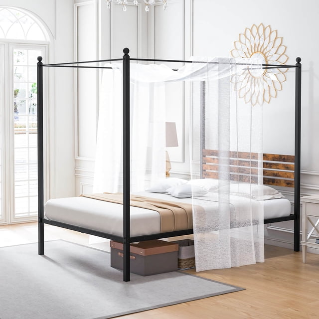 Gymax Full Size 4-Post Canopy Bed Frame with rustproof metal construction, durable slatted headboard in rustic brown and black, and decorative ball caps. Features include anti-scratch foot pads, 12-inch under-bed storage, noise-free design, and easy assembly. Displayed in a bright bedroom with sheer curtains draped over the canopy.