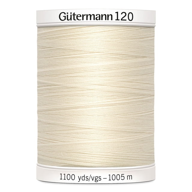 Gutermann 120 100% polyester all purpose sewing thread spool in off-white, tightly wound with label showing 1100 yards (1005 meters), suitable for machine and hand sewing on various fabrics including cotton, synthetics, and wool, also ideal for craft and mending projects.