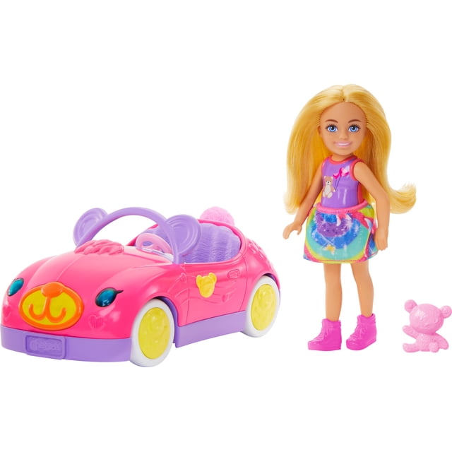 Barbie Chelsea Vehicle Set with Blonde Small Doll, Toy Car & Teddy Bear Accessory featuring a pink convertible toy car with purple steering wheel and yellow wheels, decorated with teddy bear motifs. The Chelsea doll wears a colorful skirt and purple top with teddy bear print, paired with pink shoes, standing next to a small pink teddy bear figure, suitable for imaginative road trip play.