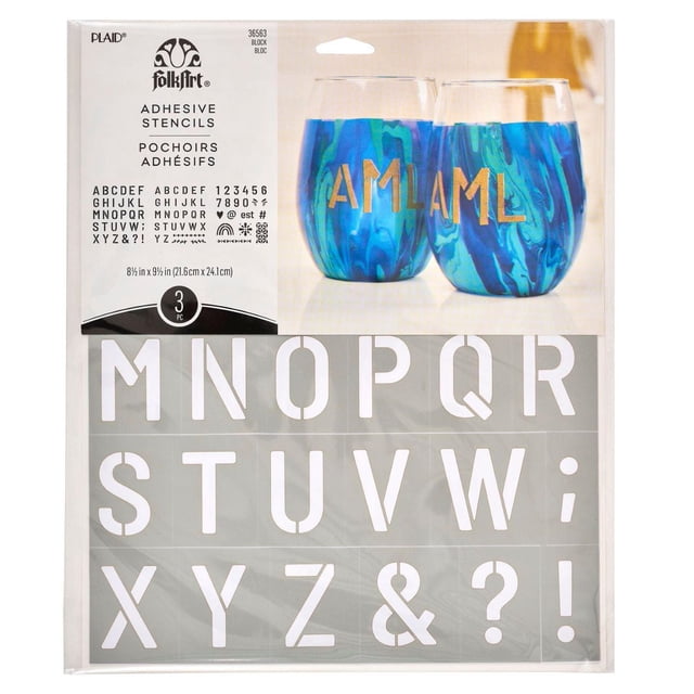 FolkArt Reusable Adhesive Letter & Number Stencil Set, 8.5" x 9.5", Block Font, 3 Pieces showing gray adhesive stencil sheets with uppercase block letters, numbers, and symbols, displayed with gold stenciled letters on blue marbled glass cups, suitable for scrapbooking, paper crafts, and multi-surface DIY projects on glass, wood, and fabric.