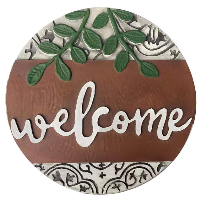 Angelo Décor Welcome Stepping Stone, 12-inch diameter, round stepping stone with a brown center band featuring the word 'welcome' in white script, surrounded by an off-white textured border with black vine patterns and green leaf accents, suitable for garden paths or decorative use.