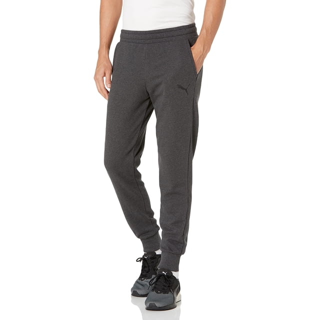 PUMA Men's Essentials Logo Sweatpants in dark gray heather, size large, designed for a regular fit with tapered legs and elastic cuffs. Made from a cotton blend material, featuring the PUMA logo on the left thigh. Ideal for casual wear or lounging, styled with sneakers.