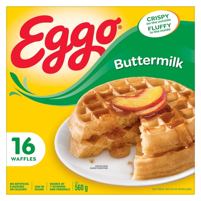 EGGO Buttermilk Waffles, 560g box showing two golden buttermilk waffles on a white plate topped with peach slices and syrup, highlighting the light, crispy texture and buttermilk taste, with packaging details including 16 waffles, low sugar, no artificial colours, and source of 7 vitamins and minerals.