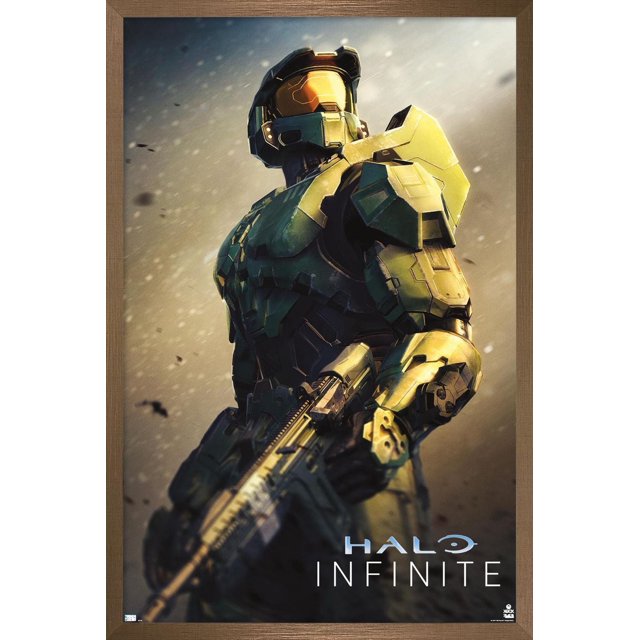 Halo Infinite - Become Wall Poster, 22.375" x 34" framed depicting Master Chief in green and gold armor holding an assault rifle against a dusty, blurred background with the Halo Infinite logo, suitable for decorating bedrooms, offices, or gaming rooms.