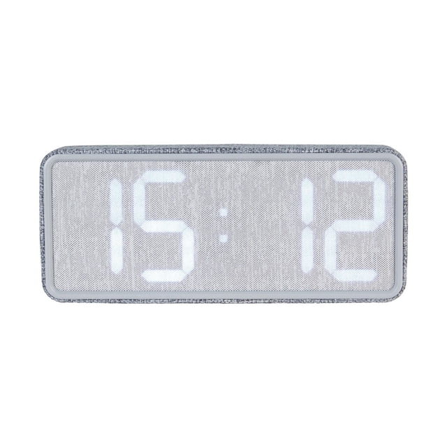 HOMETRENDS Alarm Clock with a rectangular grey fabric frame and clear plastic lens, displaying time 15:12 on a large white LED digital screen in 24-hour format, USB-powered with alarm and indoor temperature features, suitable for wall or tabletop use.
