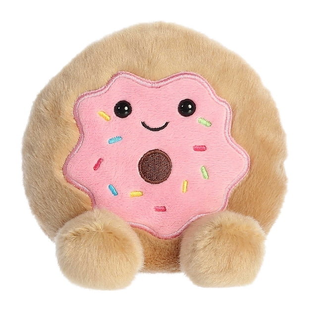 Aurora Palm Pals - Claire Donut 5-inch plush toy featuring a soft, fluffy donut-shaped design with a tan exterior, a pink frosted face with colourful sprinkles, and a cheerful embroidered smile. Made with high-quality materials and filled with bean pellets for stability, this plush is suitable for all ages.