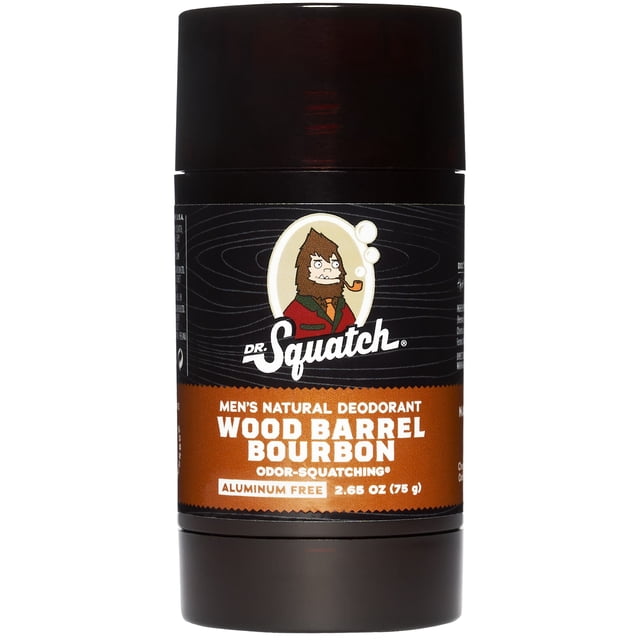 Dr. Squatch Natural Deodorant for Men Wood Barrel Bourbon in a dark brown stick container with a black label featuring a cartoon Sasquatch smoking a pipe, an orange band highlighting the scent name, aluminum-free formula, and 2.65 oz (75 g) weight, ideal for natural odor control and all skin types.