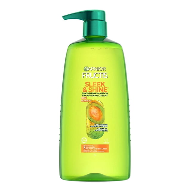 Garnier Fructis Sleek & Shine Fortifying Shampoo in a green translucent 1 L pump bottle with orange and white text, formulated with plant keratin and sustainably sourced argan oil from Morocco to smooth frizzy, dry hair and provide long-lasting frizz control even in 97% humidity, also suitable for daily use.