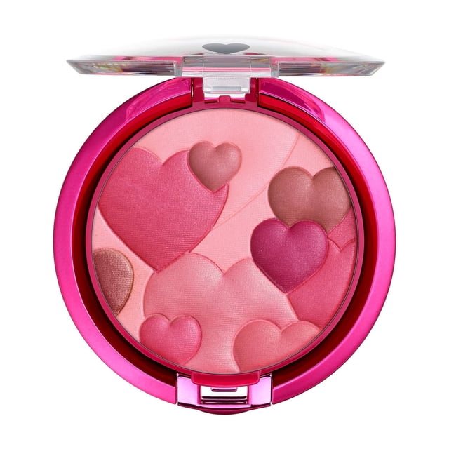 Happy Booster Happy Glow Fard à Joues Multicolore par Physicians Formula, Montré en Gros Plan d'Un compact Rond Ouvert avec Fard à Joues Multicolore en Forme de Cœur en Teintes Rose, mauve et Pêche, Abrité dans un Étui Métallique Rose Vif avec un Couvercle Transparent Présentant un Symbole de Cœur, Offrant une Couleur Rayonnante et une Douce iridescence pour Mettre en Valeur et Sculpter les Joues avec un Doux Parfum floral d'Agrumes.