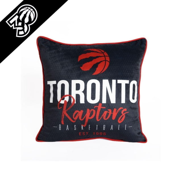 NBA Toronto Raptors Basketball Throw Pillow (18 x 18 in), black square decorative pillow with red piping, featuring a red clawed basketball logo above white 'TORONTO' and red 'Raptors' text, plus 'Basketball Est. 1995' below, suitable for NBA fan home decor or game day comfort.