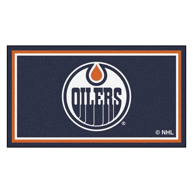NHL-Edmonton Oilers 3x5 Rug displaying a centered Edmonton Oilers logo with a white circle and orange oil drop above navy blue 'OILERS' text on a navy blue background bordered by white and orange stripes, made of 32 oz nylon with non-skid latex backing, ideal for game rooms, offices, or man caves.