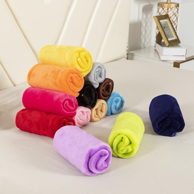 Clearance Items! Super Soft Warm Warm Fleece Blanket Throw Rug Sofa Bedding in grey color by HUTIPVCX. The image shows multiple rolled fleece blankets in various vibrant colors, including yellow, orange, red, pink, purple, blue, and grey, arranged on a beige bed. These flannel blankets are made of microfiber, measuring 70x100 cm, and are designed for warmth and comfort. Suitable for use as a throw blanket on sofas or beds.