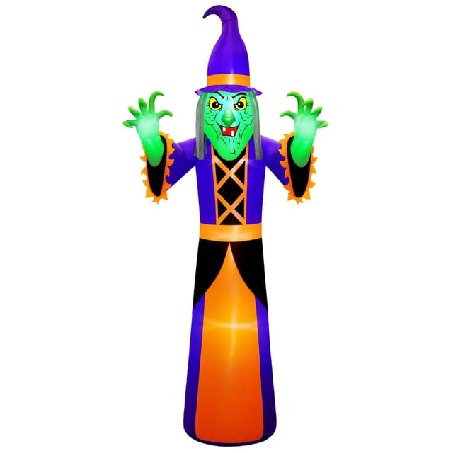 Occasions Halloween 20 Foot Inflatable Giant Witch with a green face, yellow eyes, and fangs, wearing a purple pointed hat and a purple and orange dress with black accents. The witch’s glowing green hands and internal lighting make it ideal for indoor or outdoor Halloween decoration.