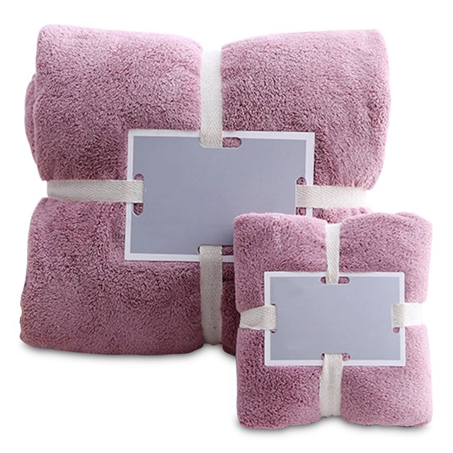 Bathroom Shower Towels Set Bath Towel Hand Towels Soft Fluffy in a pink color, made of high-quality coral fleece. The set includes one bath towel measuring 70x140cm and one hand towel measuring 35x75cm. The towels are soft, durable, and fast-drying, suitable for use in the bathroom, gym, or while traveling. Both towels are neatly folded and secured with white straps, displayed against a plain background.