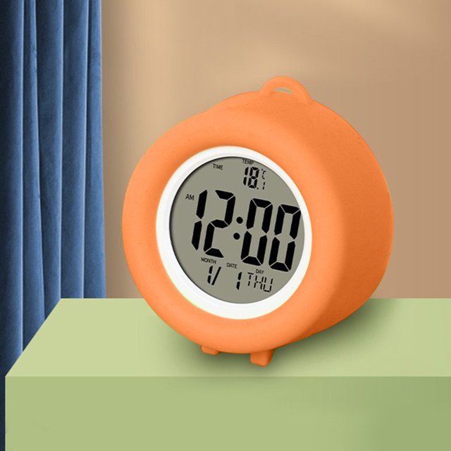 TopLLC Digital Electronic Clock with LED display in orange ABS material, featuring a stereo digital display, snooze alarm, and 12/24-hour switching. The compact clock measures 2.75 x 2.63 x 1.25 inches and includes a countdown timer function. Displayed on a green surface with a beige and blue curtain background.