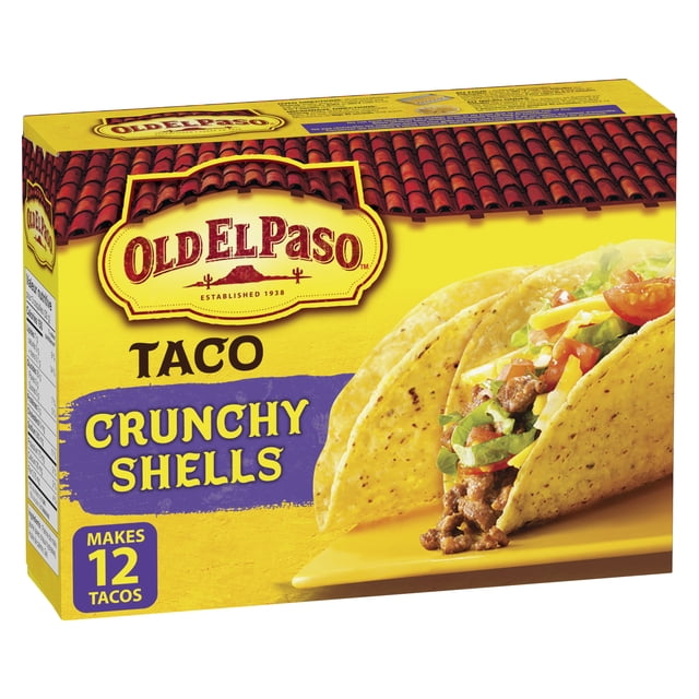 Old El Paso Gluten Free Taco Crunchy Shells box containing 12 yellow corn taco shells with visible grain specks, displayed with a filled taco of ground beef, shredded cheese, lettuce, and tomato on a yellow plate, featuring the Old El Paso logo and red tile roof design, ideal for gluten-free Mexican meals.