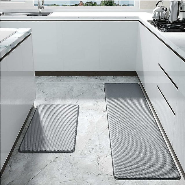 Kitchen Mat, Grapes Wine Rugs, Thick Cushioned Anti Fatigue Floor Mat for Kitchen displayed in a sleek kitchen environment. The grey mat, crafted from foamed PU material, offers anti-fatigue support and features a non-slip PVC backing for stability. Waterproof and easy to clean, it is suitable for use in kitchens or laundry rooms.