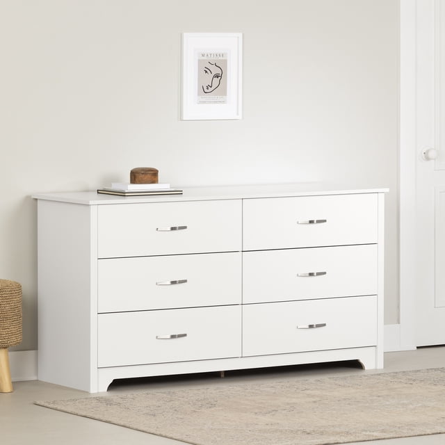 South Shore Fusion 6-Drawer Dresser for Adult in pure white with six spacious drawers featuring slim metal handles, straight lines, and clean-cut bottom molding, set against a beige wall with a framed minimalist art print above and a neutral rug below, suitable for organized bedroom storage.