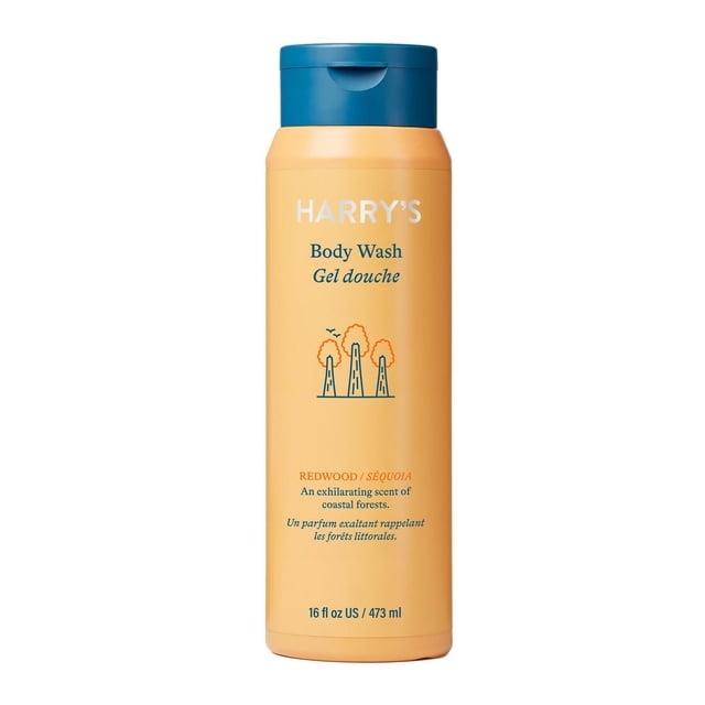 Redwood Body Wash by Harry's in a 473 ml orange bottle with a blue flip-top cap, featuring minimalist tree graphics and text describing its coastal forest scent. This bath and shower gel cleanses deeply while being gentle on skin.