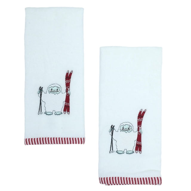 Holiday Time Hand Towels set of two white 100% cotton towels measuring 16 by 26 inches each, embroidered with a yeti holding red skis and black ski poles, featuring red and white striped trim, ideal for bathroom use or seasonal décor.