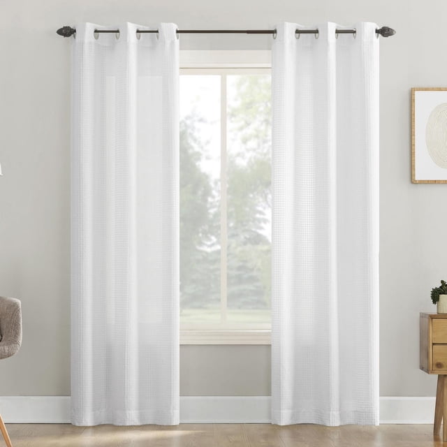 Mainstays 2-Pack Waffle Semi-Sheer Grommet Window Curtains Panel Pair in white, featuring waffle-textured semi-sheer fabric that gently filters light and enhances privacy, with metal grommets fitting rods up to 1.5 inches diameter, displayed in a bright, neutral room.