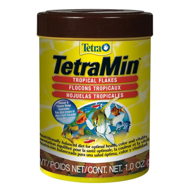 TetraMin Fish Food Flakes for Tropical Fish in a yellow container with a brown lid, featuring tropical fish illustrations and text highlighting a nutritionally balanced formula with immunostimulants, omega 3 fatty acids, and vitamins for optimal health, color, and vitality, designed to maintain clean and clear aquarium water.
