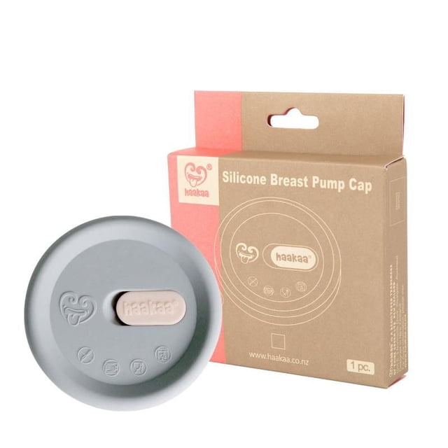 haakaa Grey Silicone Lid (Fits All Pumps) with its packaging, a round grey silicone breast pump cap featuring a central beige tab embossed with the haakaa logo, made from 100% food-grade silicone to seal and protect breast pumps from spills and contamination, ensuring hygiene between uses.