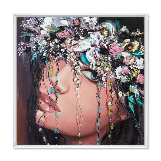 Designart Portrait Of A Young Lady With Flowers II FLOAT FRAME WALL ART depicts a close-up side profile of a young woman with blue eyes and full lips, adorned with textured cascading flowers in pink, white, teal, and yellow. The gallery-wrapped premium cotton canvas is stretched over a 1-inch wood subframe and set in a white floating frame, arriving ready to hang in home décor spaces.