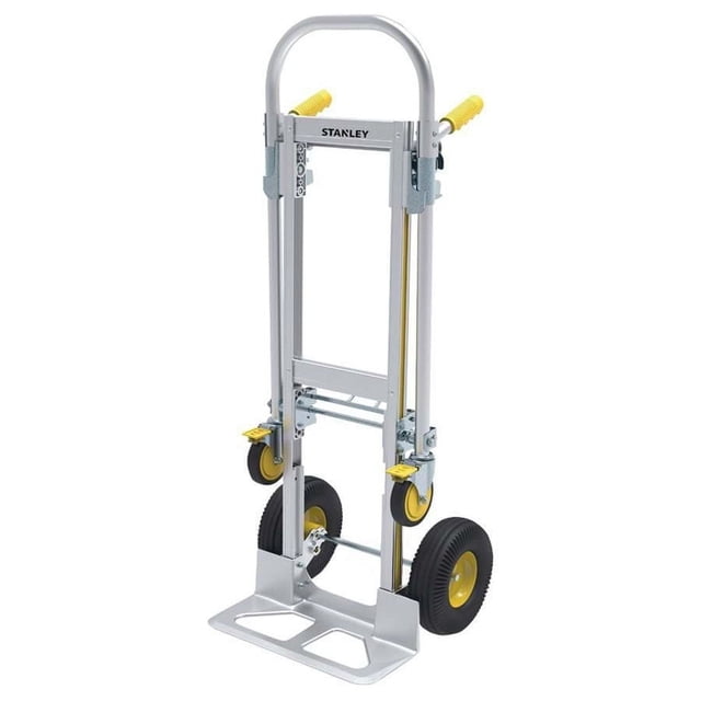 STANLEY MT515 Industrial Aluminum Hand & Platform Truck folded with silver aluminum frame, yellow handles, and large black pneumatic wheels with yellow hubs, suitable for portable storage and heavy-duty utility tasks in home or industrial settings.