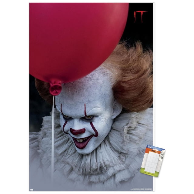 IT - Balloon Wall Poster, 14.725" x 22.375" featuring a close-up of a character with cracked white face paint and orange hair, partially obscured by a large red balloon, wearing a detailed white ruffled collar on a dark background with the red 'IT' logo in the top right corner, ideal for horror-themed room decor or party decoration.
