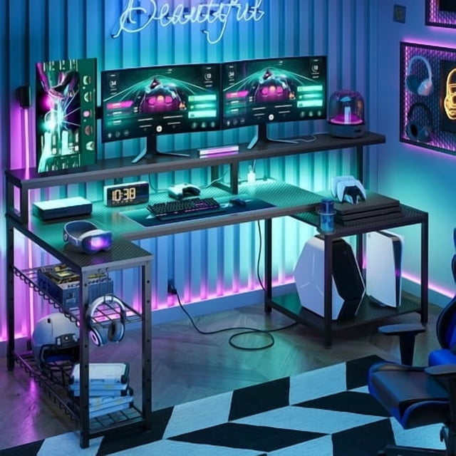 Bestier Gaming Desk with Power Outlets, 71.5-inch LED computer desk with an L-shaped corner design in carbon fiber black. Features a long monitor stand for dual monitors, adjustable storage shelves for gaming equipment, a cup holder, and headset hooks. RGB LED lights provide customizable colours and dynamic modes, enhancing the gaming experience. Positioned in a modern gaming room with neon accents and gaming accessories.