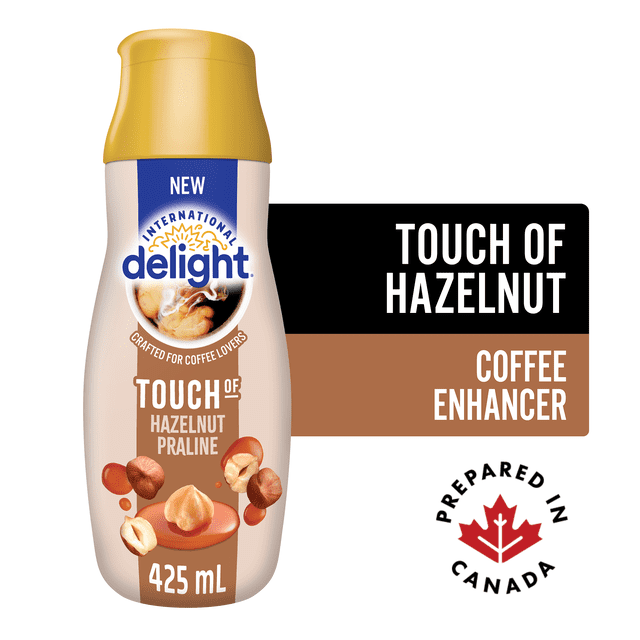 International Delight Touch of Halzenut Praline 425mL single 425mL labeled bottle of International Delight with product name visible on the label and white screw cap; suitable for adding hazelnut-praline flavor to hot beverages or often used as a dessert flavoring.